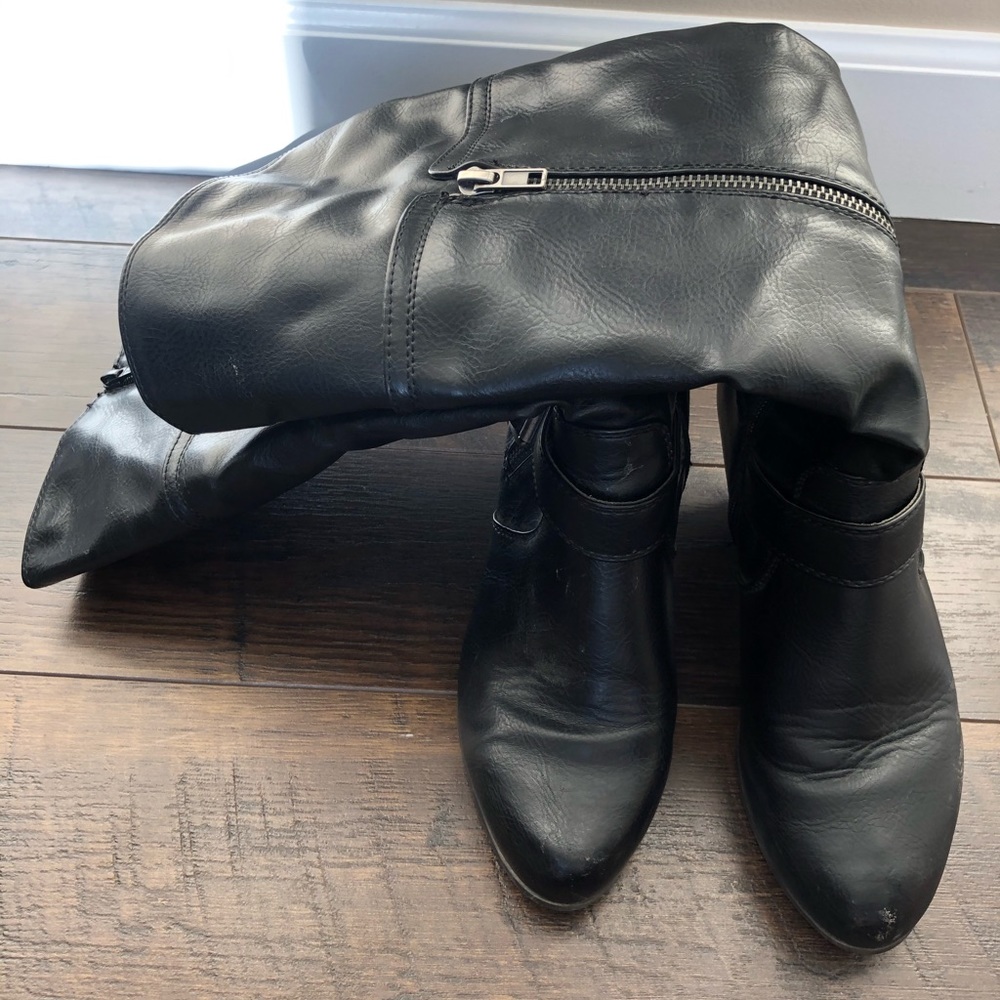 Black tall heeled dress boots.